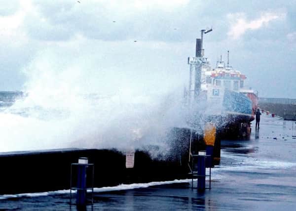 Big waves with the tidal surge at Seahouses harbour Picture by Jane Coltman