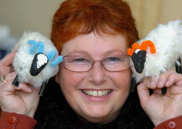 Sue Cansdale with two of the sheep she made that went on a globe-trotting adventure. Picture by Peter McCartney.