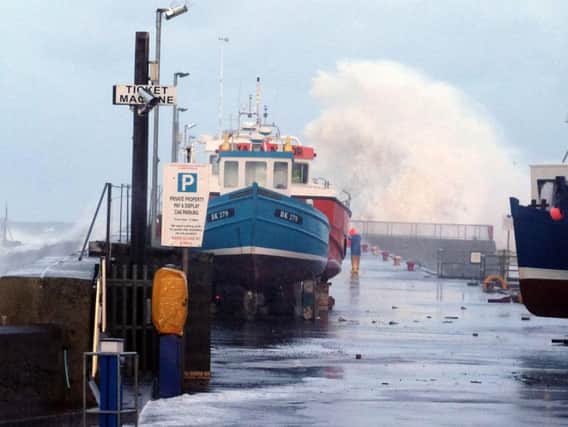 Big waves during a tidal surge at Seahouses harbour last January. Picture by Jane Coltman