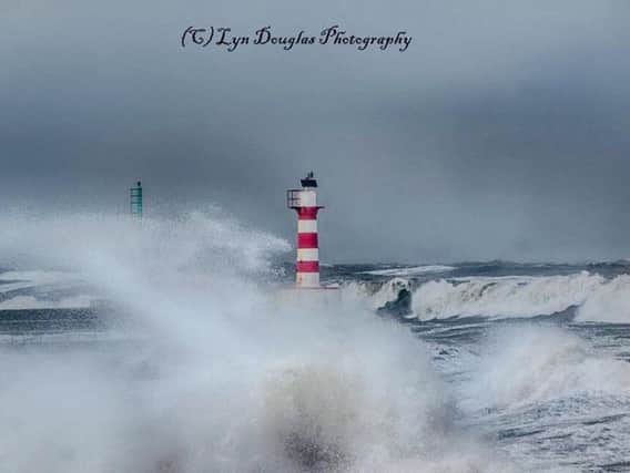 Lyn Douglas pictured the dramatic waves during the tidal swell at Amble on Friday.