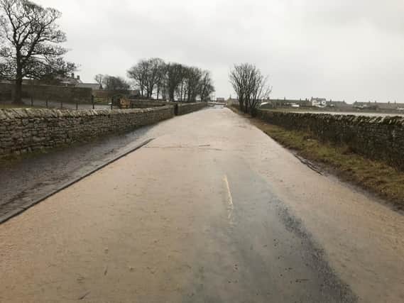 Floodwater on the road at Boulmer earlier today. Picture by Paul Larkin