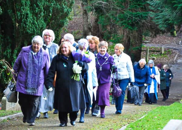 The congregation walk from St Mary's Church to the churchyard. Picture by Doug Harrison.