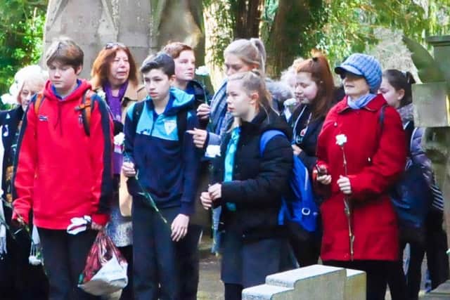 A group of young people attended the service and went to the churchyard afterwards. Picture by Doug Harrison.