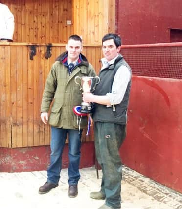 Harrison and Hetherington held their Annual Show and Sale of Store Cattle at Wooler for The Robin Scott Trophy. Left: The judge Mr Nigel Leighton, Fairfield Farm, Goole presenting The Robin Scott Trophy to Aydon Carse, South Ord.