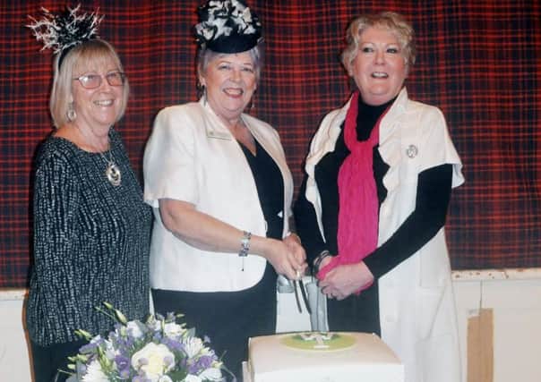 Alnmouth WI celebrating 100 years of continuous presence in the village. Left to right:  Barbara Kilkenny and Marjorie Read, members of the Northumberland Federation of WIs, and Janis Crook, President of Alnmouth WI