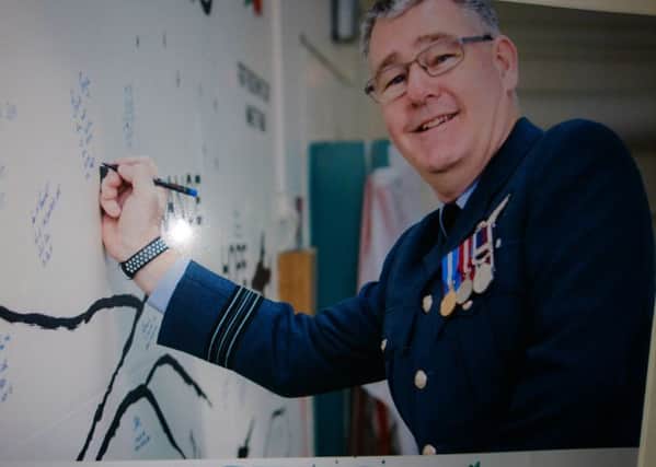 Squadron Leader Stephen Bryce signing the wall of honour.