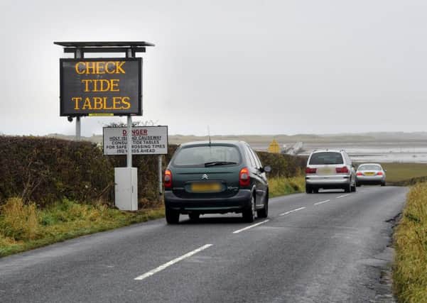 One of the signs on Holy Island encouraging people to check the tide times for the causeway.