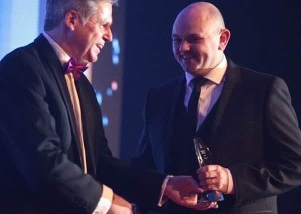 Will Blackshaw, managing director of Blackshaws Mitsubishi, right, collects the award for New Dealership of the Year from Lance Bradley, managing director for Mitsubishi Motors in the UK.