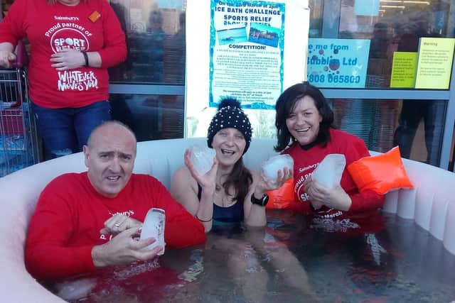 Gerry Storey, Jane Hardy and Anita McDonald in the pool of freezing water outside Sainsbury's Alnwick.
