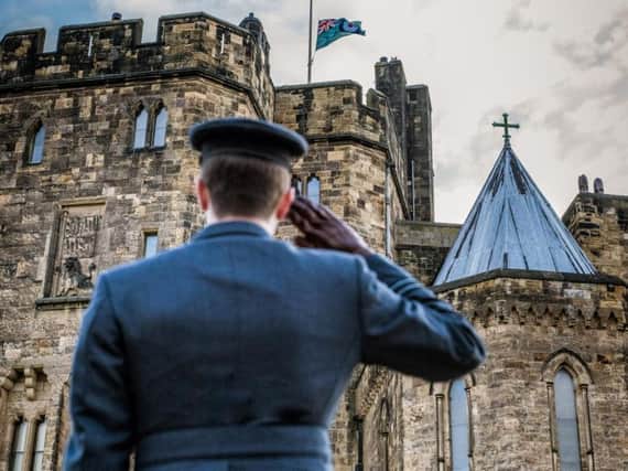 Flight Lieutenant Nicholas Byrne takes the salute at Alnwick Castle.