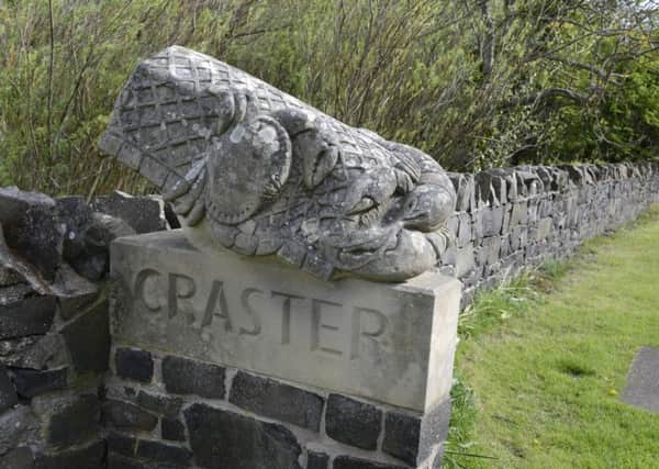 The stone carving at the entrance to Craster.
Picture by Jane Coltman