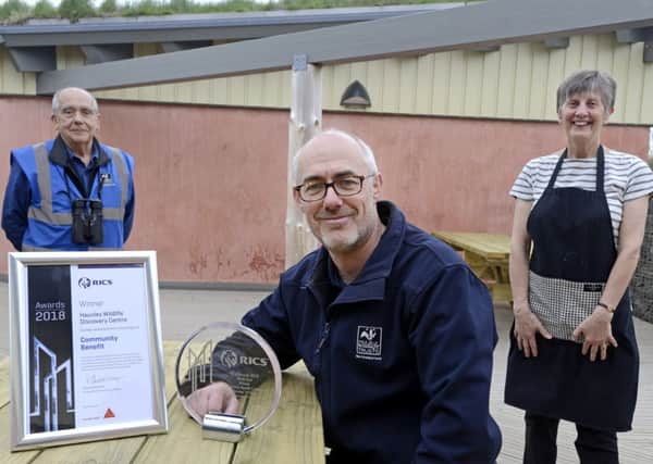Northumberland Wildlife Trust's Duncan Hutt with the RICS award, information assistant Geoffrey Bradford and cafe volunteer Anne Baxter at Hauxley Wildlife Discovery Centre. Picture by Jane Coltman