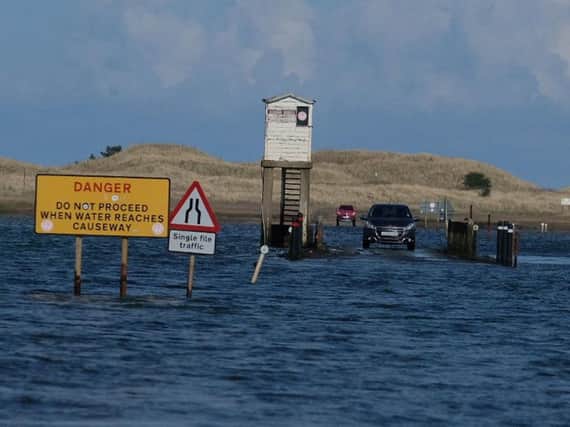 The car trapped by the tide on Holy Island causeway. Picture by Jane Coltman