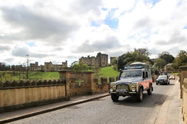 The Land Rover convoy on the Lion Bridge, Alnwick. Picture by Andy Cowan