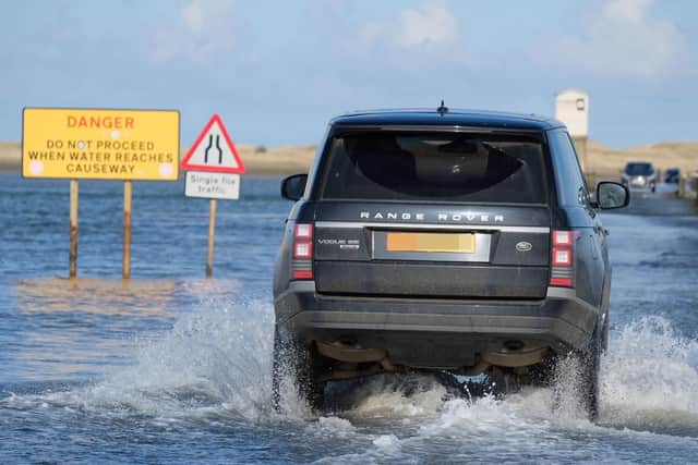 A Range Rover drives out towards the stranded car. Picture by Jane Coltman