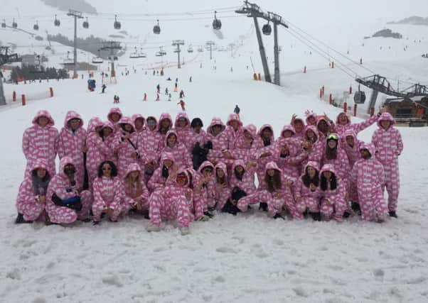 Staff and students at Westminster School in their pink onesies made by The All-in-One Company.
