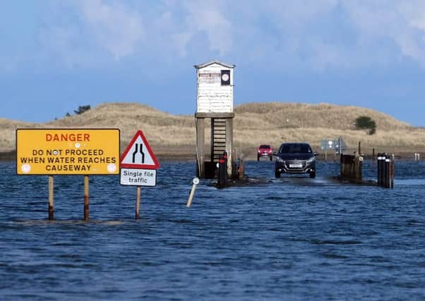The car trapped by the tide on Holy Island causeway last month. Picture by Jane Coltman