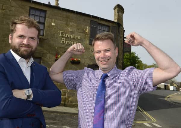 Grant Welsh, from Specsavers, and strongman competition organiser Jonathan Park outside the Tanners Arms in Alnwick. Picture by Jane Coltman