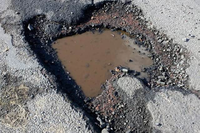 A pothole on the Sharperton road, which wrecked the tyre of a car driven by Christine Chalk.