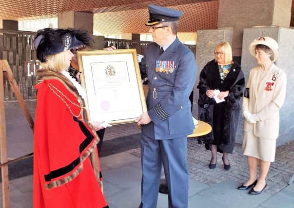 The Lord Mayor of Newcastle, Coun Linda Wright, presents the Freedom scroll to RAF Boulmer Station Commander Group Captain Rich Jacob.