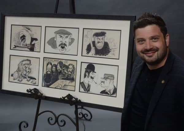 Northumberland Auction House auctioneer Adam Barr with the collection of six original pictures by the late Scott Dobson.
