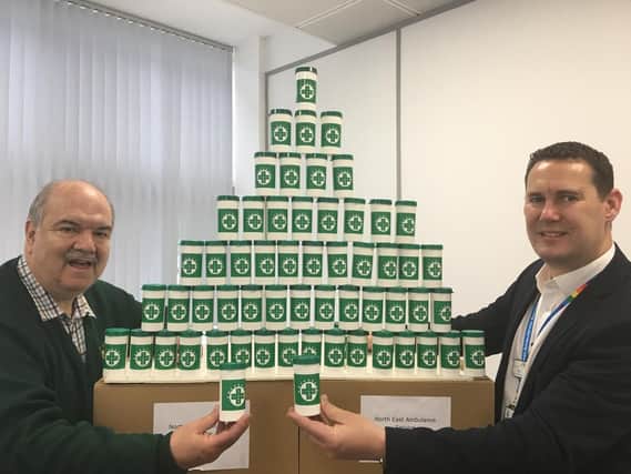 Adrian Lazenby from the Lions Clubs International in the North East handed over 1,000 bottles to Mark Johns, the head of engagement and diversity at NEAS.