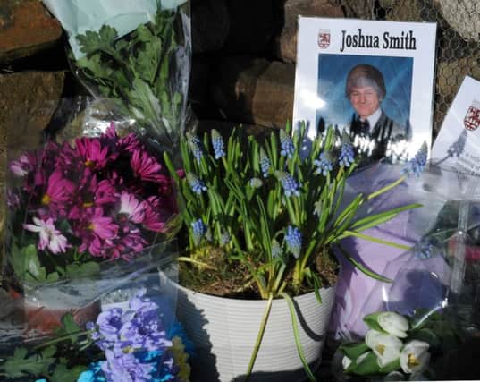 Flowers and tributes left for Joshua Smith in the 'Africa Garden' at Berwick Academy