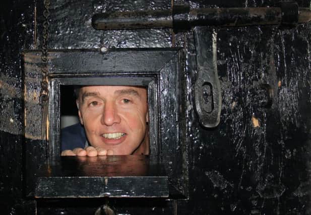 Colin Fleetwood checks out the view from inside the condemned cell.